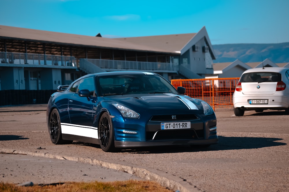 a blue sports car parked in a parking lot