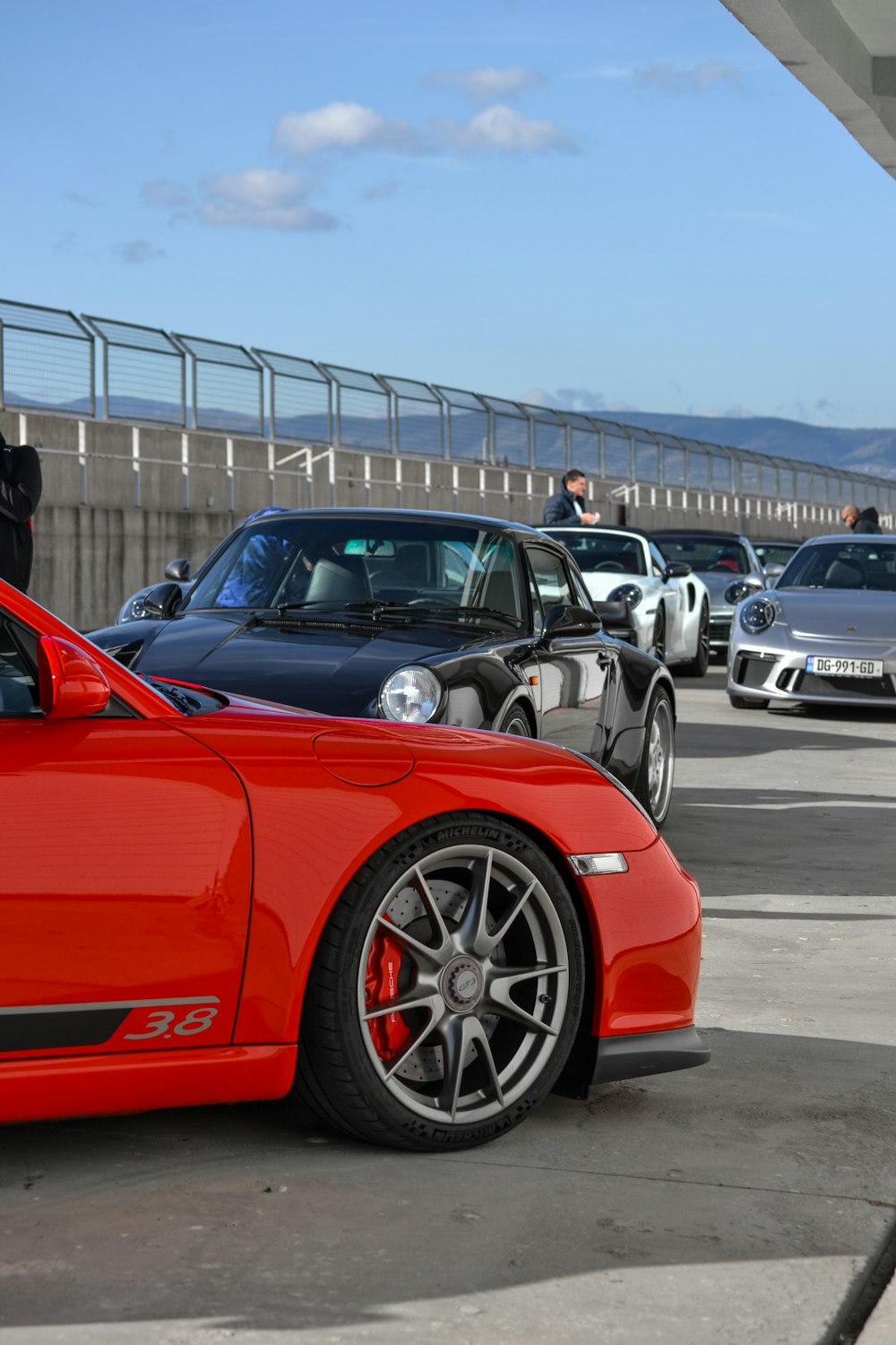 a red sports car parked in a parking lot