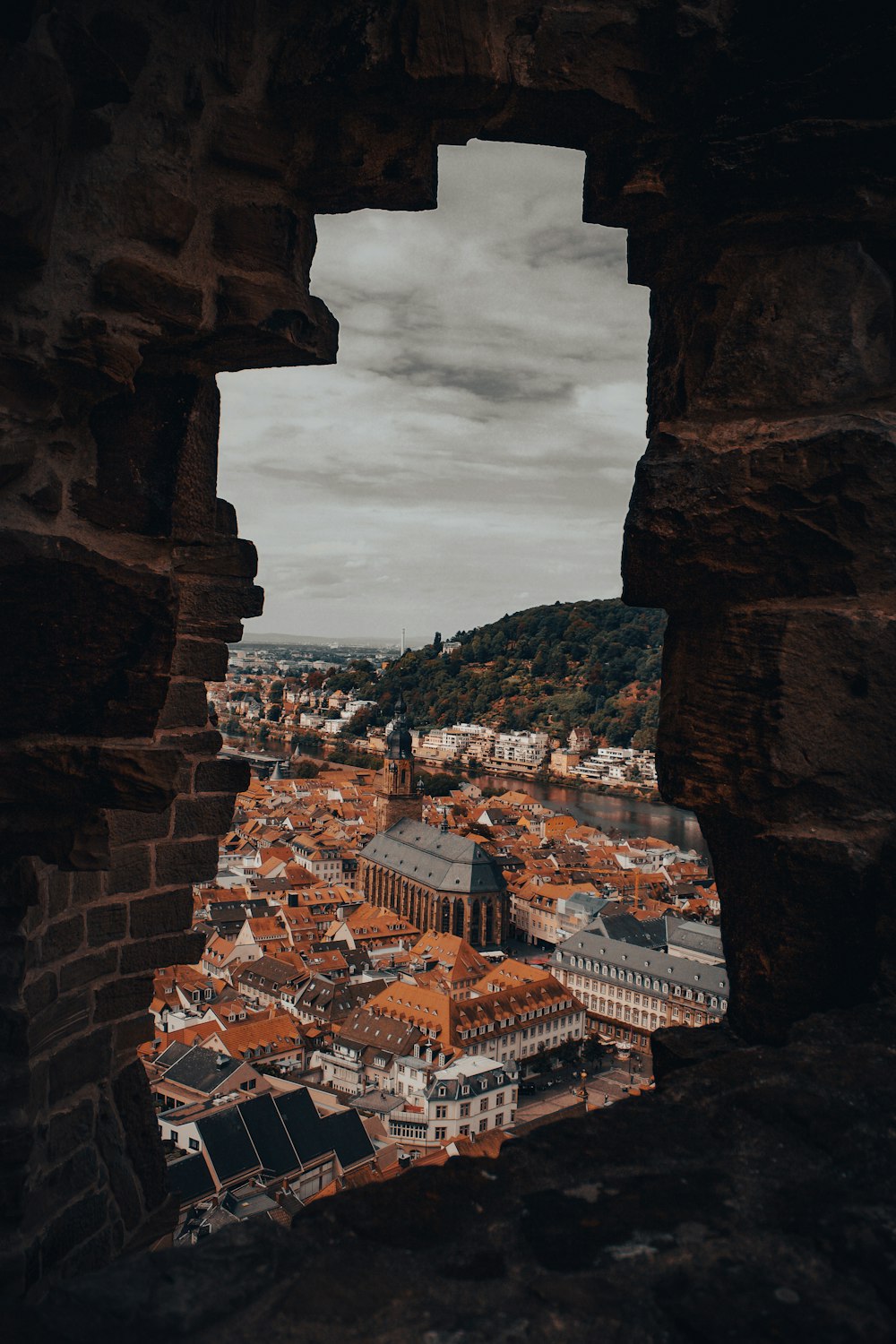 a view of a city through a hole in a wall