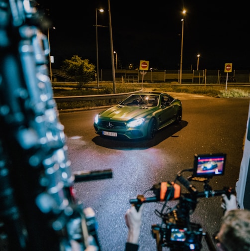 a car driving down a street at night