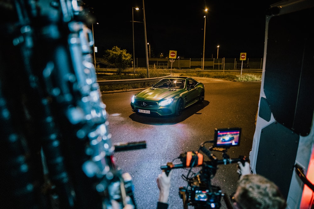 a car driving down a street at night