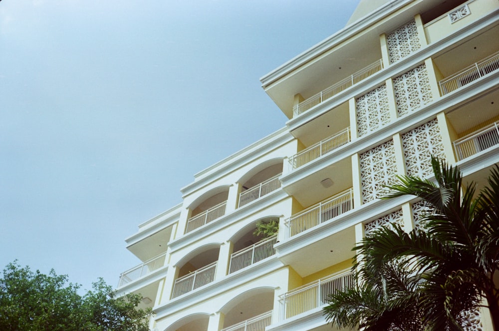 a tall white building with balconies and balconies