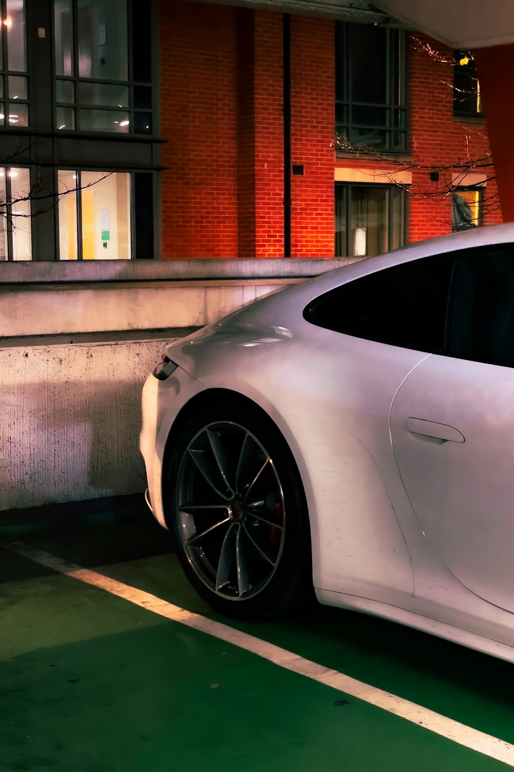 a white sports car parked in a parking lot