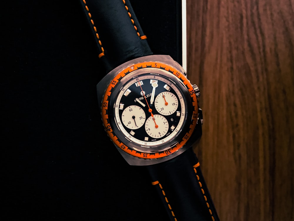 a watch sitting on top of a wooden table