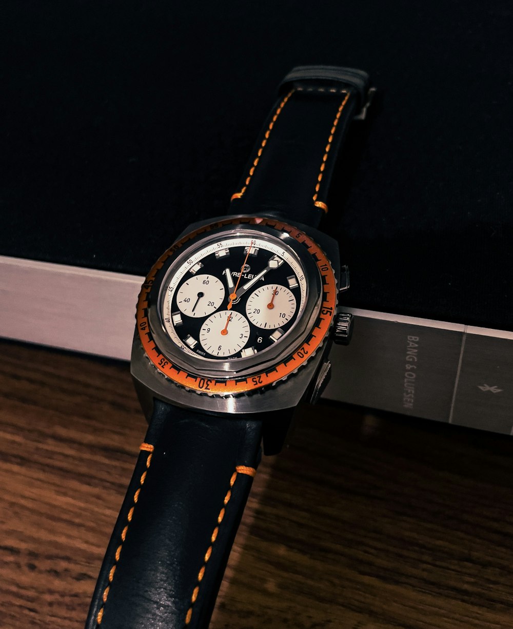 a watch sitting on top of a wooden table