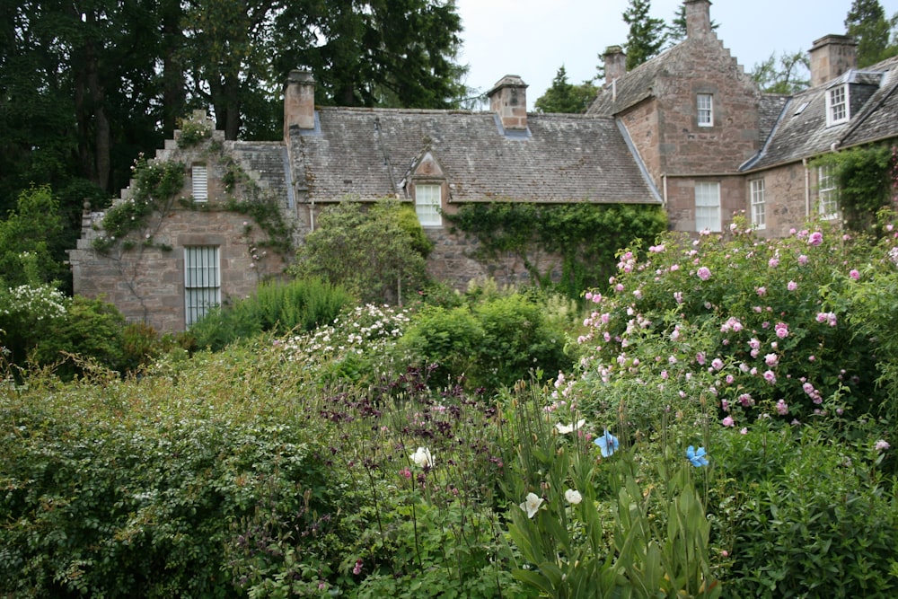 a house with a lot of flowers in front of it