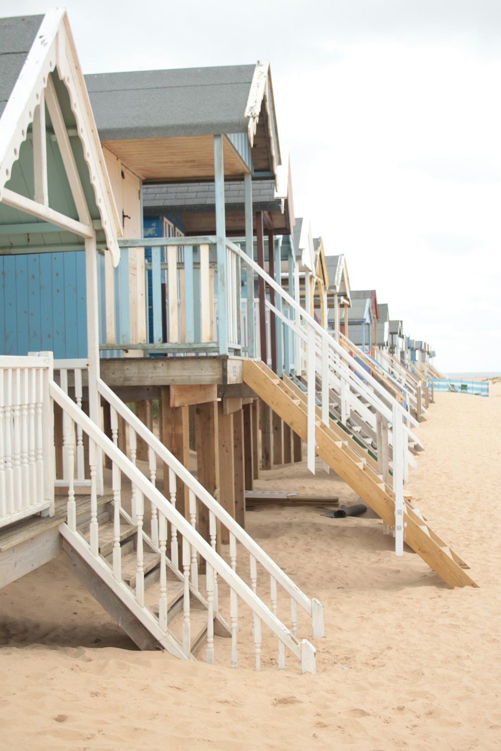 a row of beach huts on a sandy beach