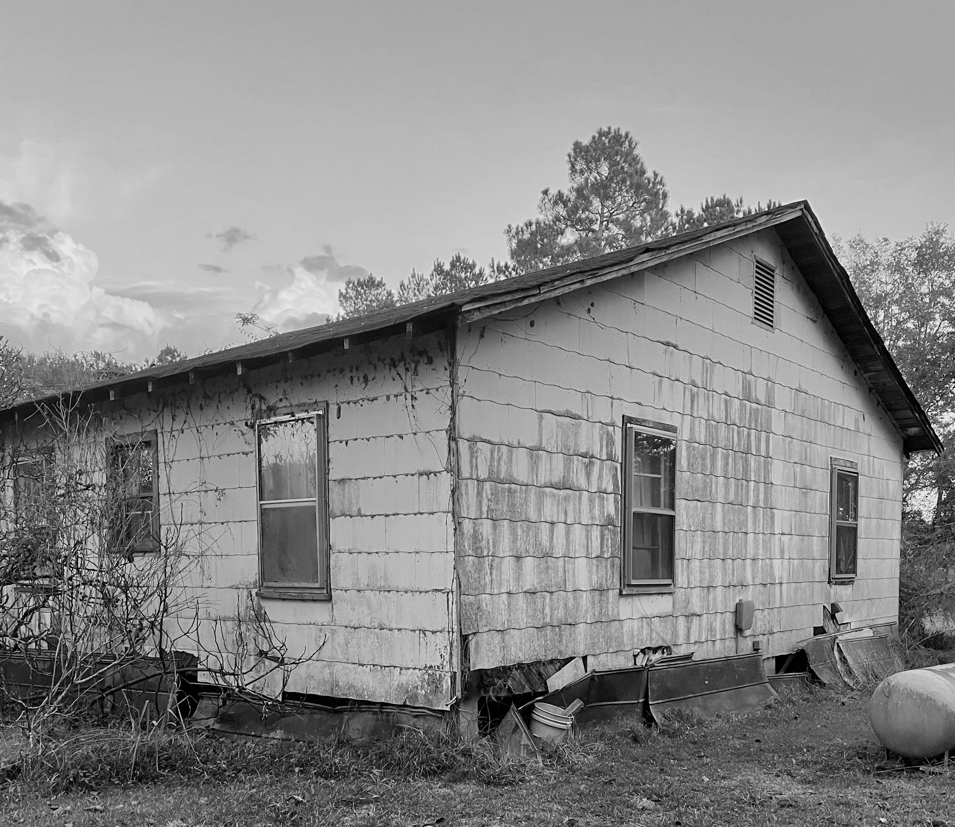 a black and white photo of an old house