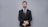 a man in a suit and tie posing for a picture