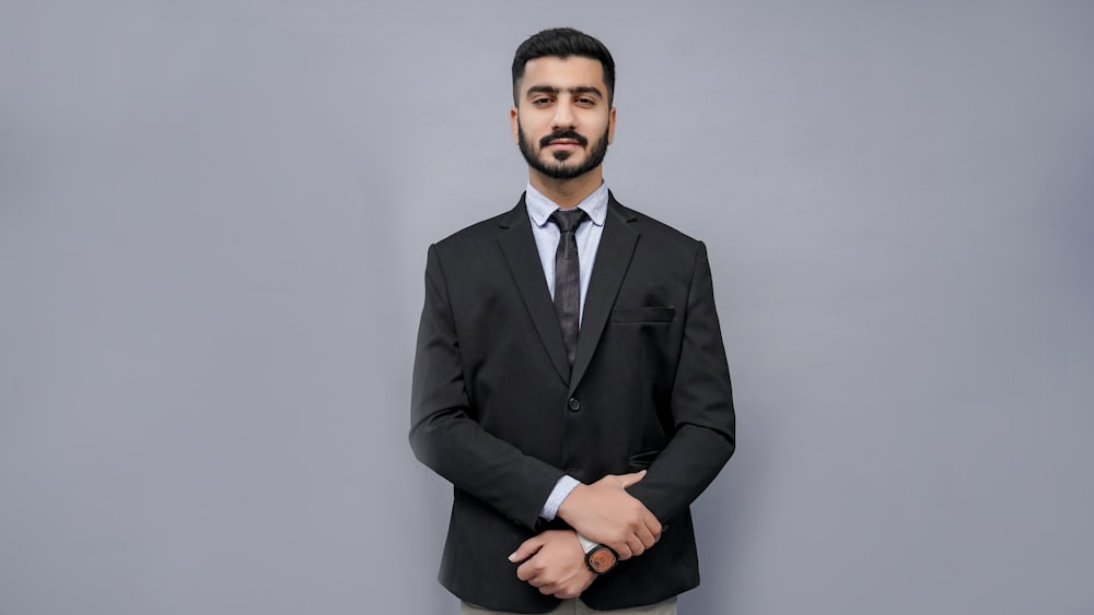 a man in a suit and tie posing for a picture