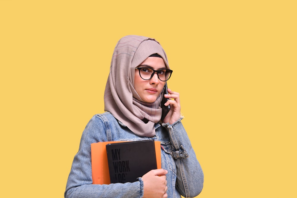 a woman in a hijab talking on a cell phone