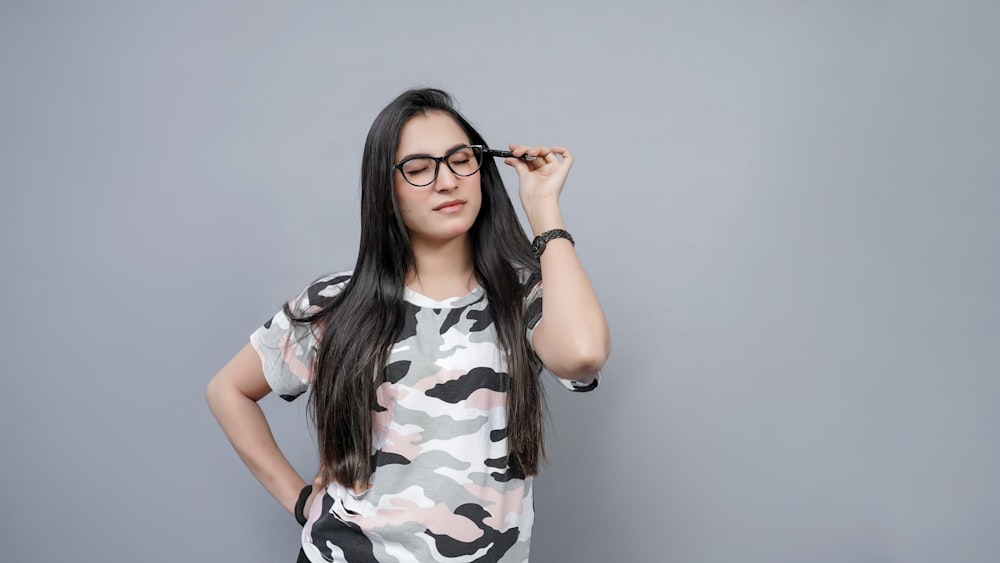 a woman wearing glasses is posing for a picture