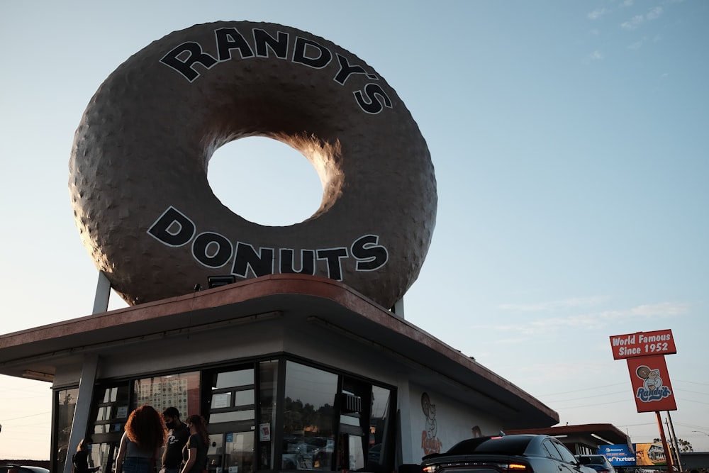 a giant donut sitting on top of a donut shop