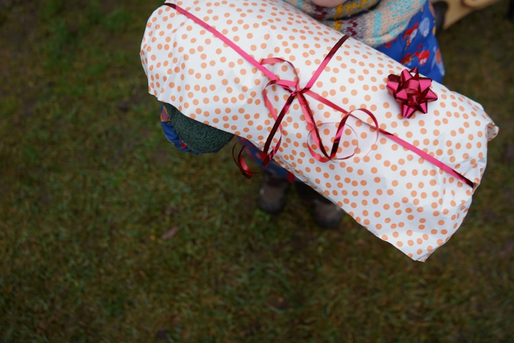a person holding two wrapped presents in their hands