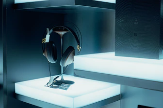 Photo of modern flat-screen TVs and headphones displayed in a sleek showroom