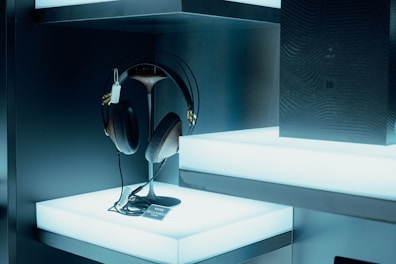 A collection of trendy earphones and headphones displayed neatly on shelves.