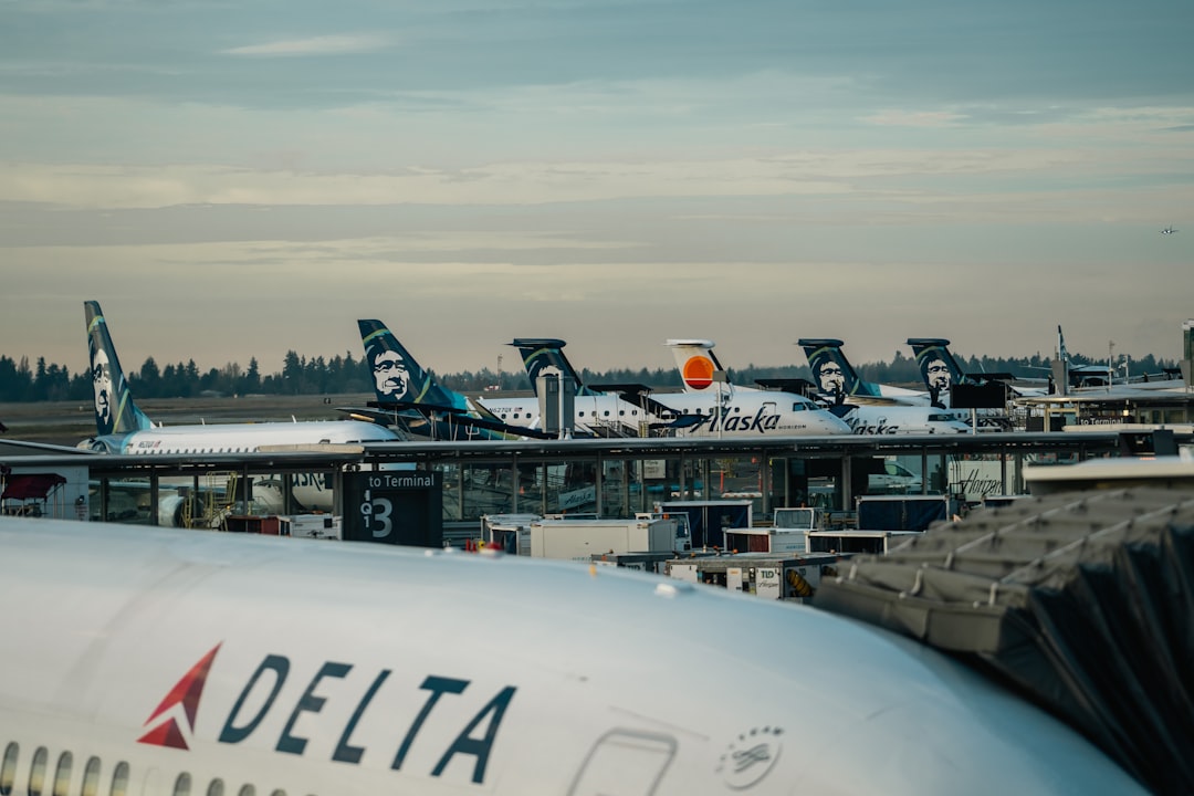 a group of airplanes parked at an airport,