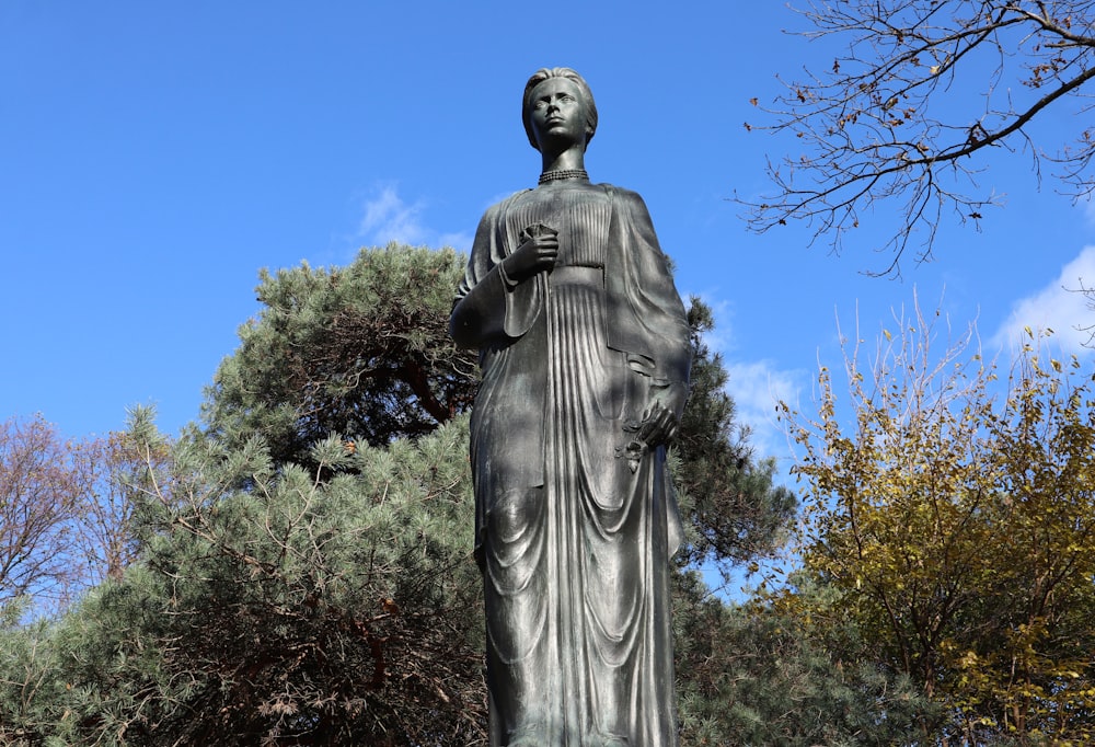 a statue of a woman holding a cross