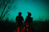 Night vision view of soldiers coordinating around advanced communication equipment.