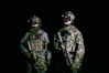 two military men in full gear standing next to each other