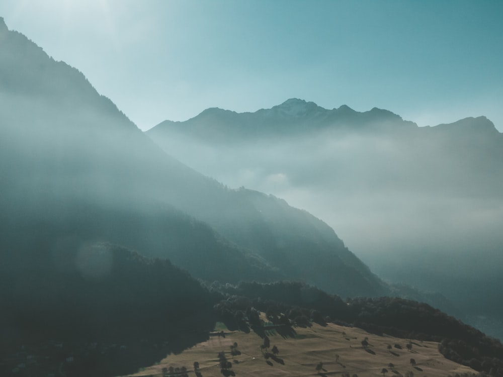 a view of a valley with mountains in the background