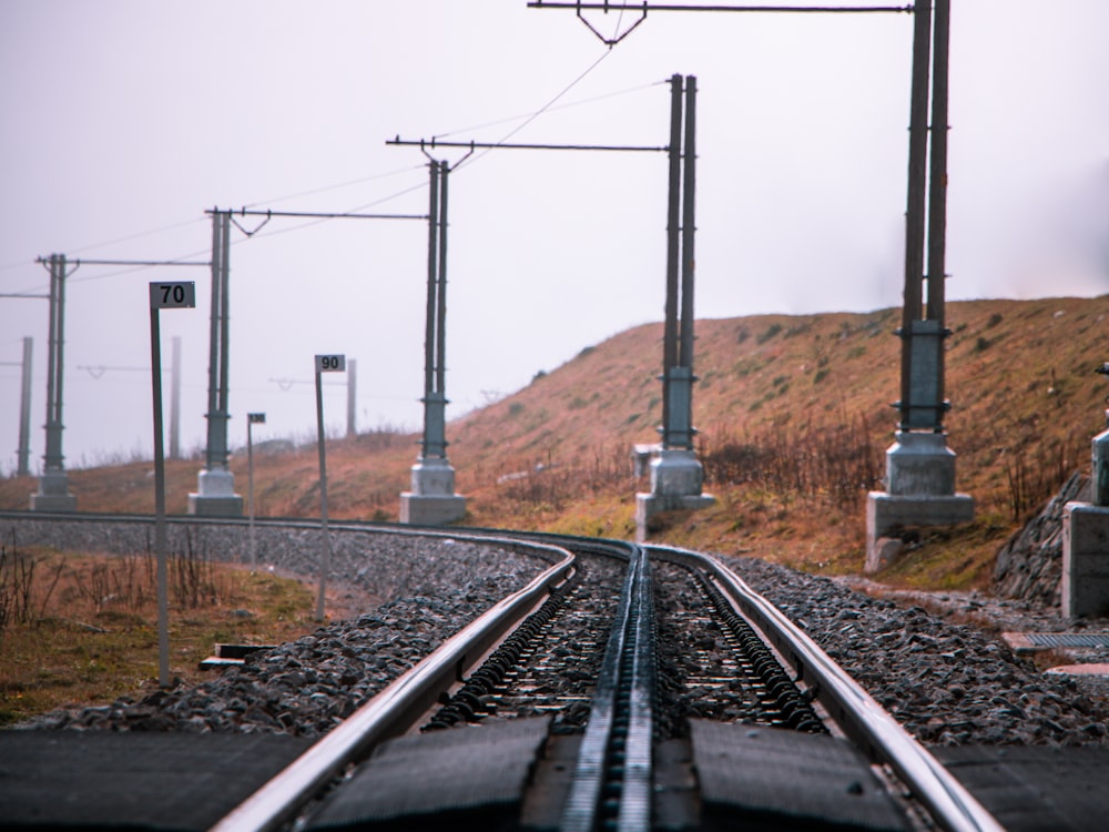 a train track with a hill in the background