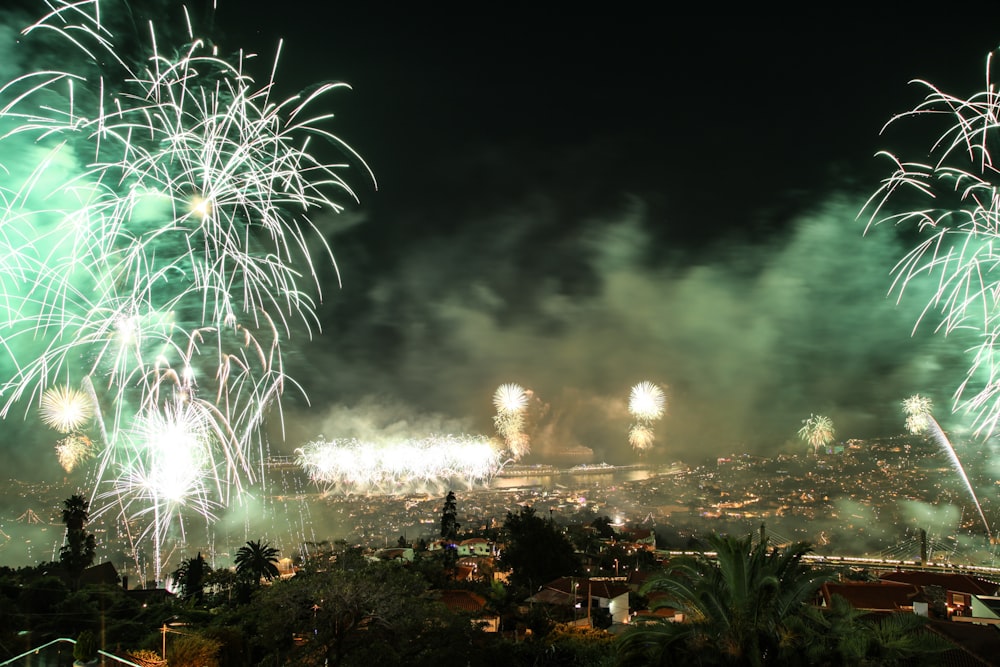 fireworks are lit up in the night sky above a city