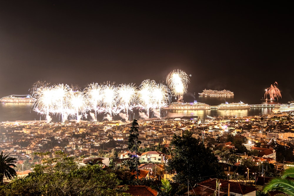 fireworks are lit up over a city at night