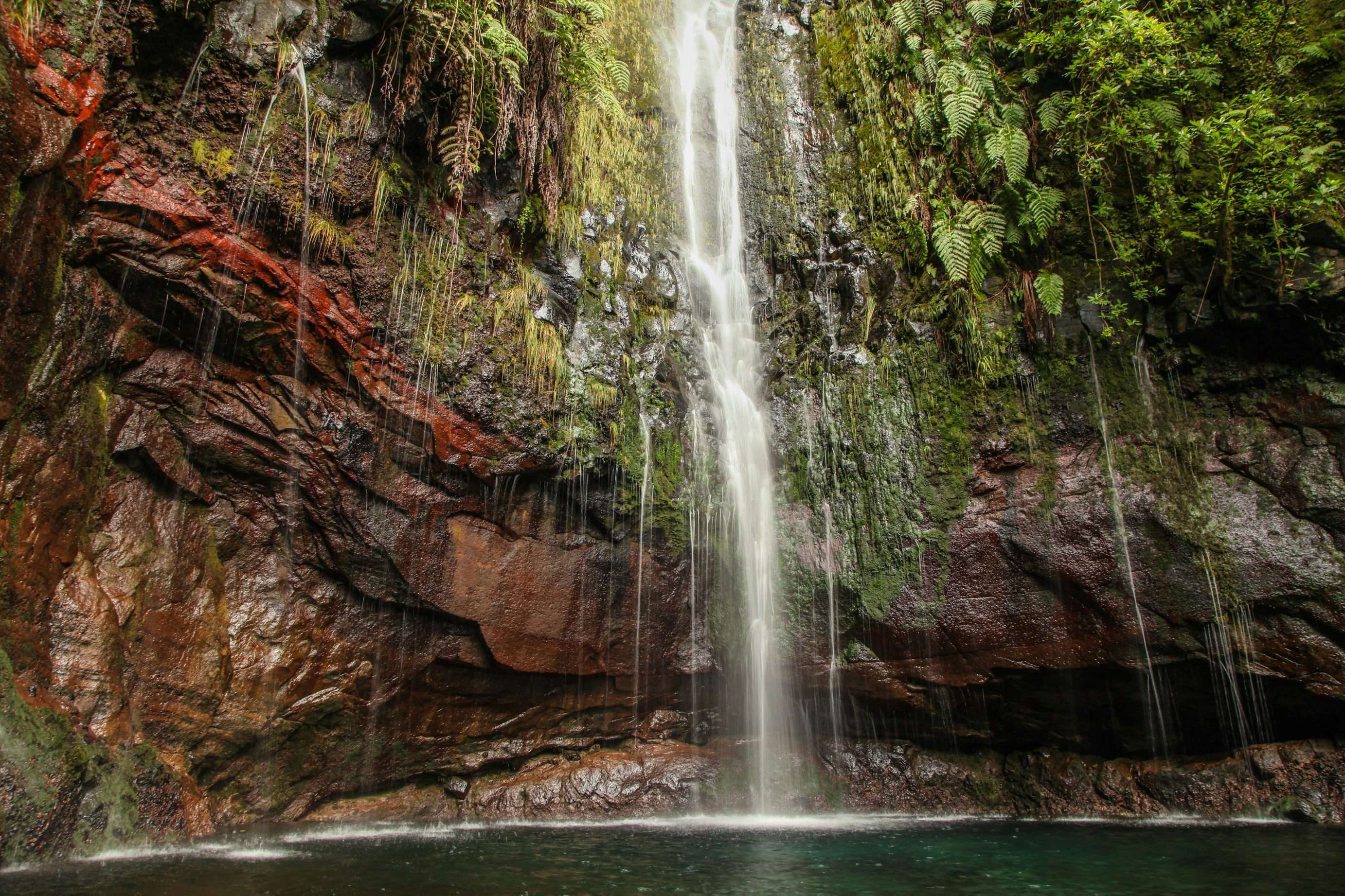 a waterfall with a pool in the middle of it, 