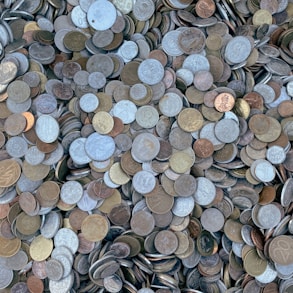 a pile of different types of coins