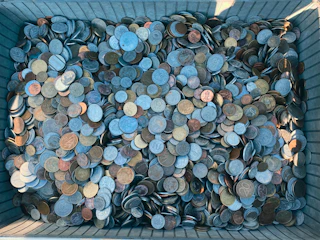 a bin filled with lots of different types of coins
