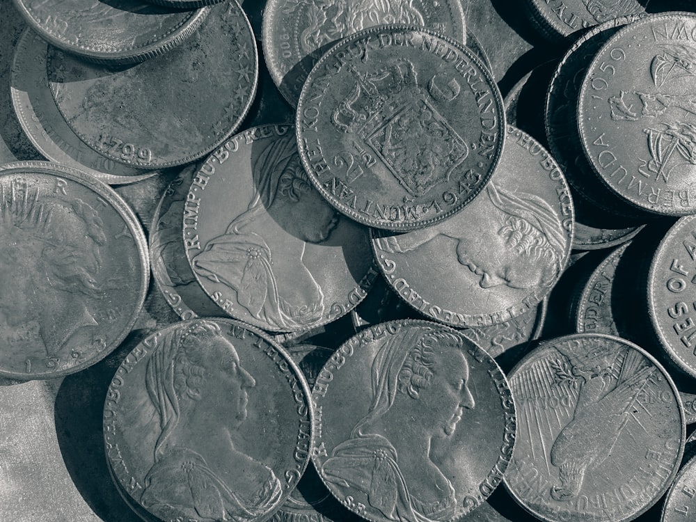 a pile of silver coins sitting on top of a table
