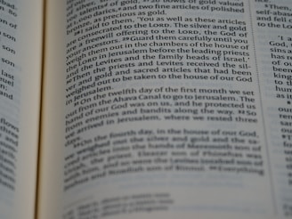 A close-up view of an open page from a book containing text that appears to be from a religious or historical text. The lines are in a serif font with certain words highlighted in bold, suggesting importance or emphasis.
