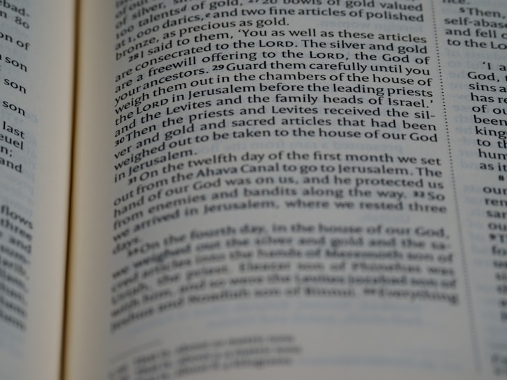 A close-up view of an open page from a book containing text that appears to be from a religious or historical text. The lines are in a serif font with certain words highlighted in bold, suggesting importance or emphasis.