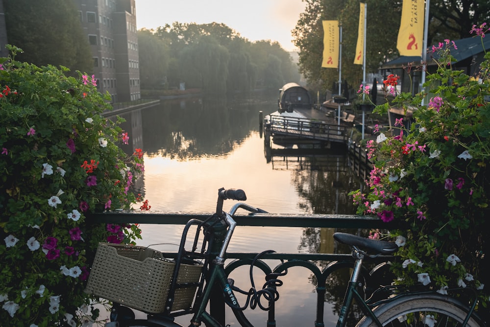 a bicycle parked next to a railing near a body of water