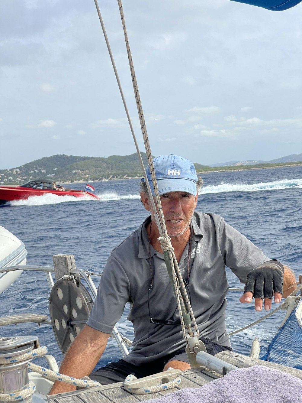 a man sitting on a boat in the ocean