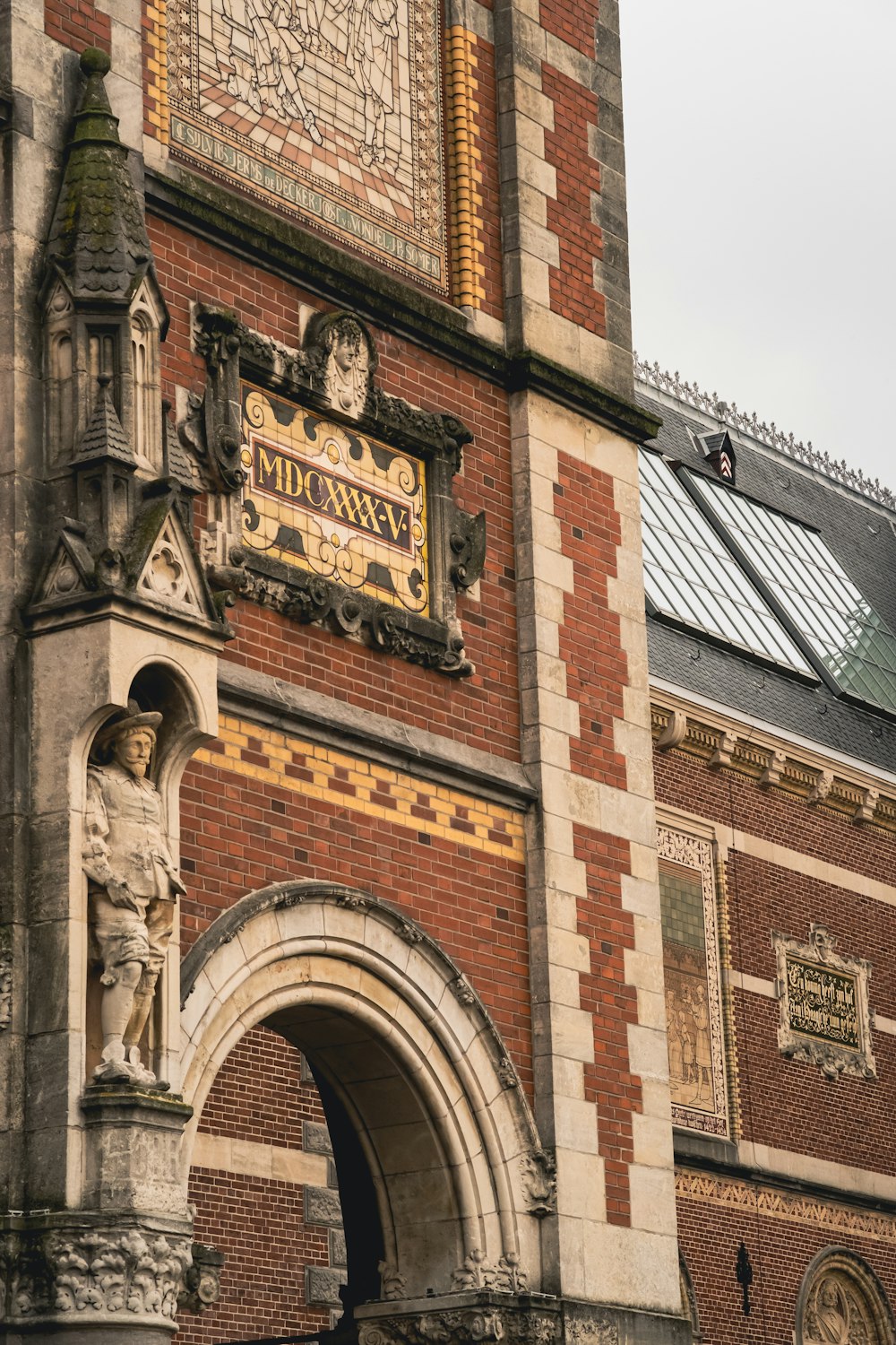 a tall brick building with a clock on it's side