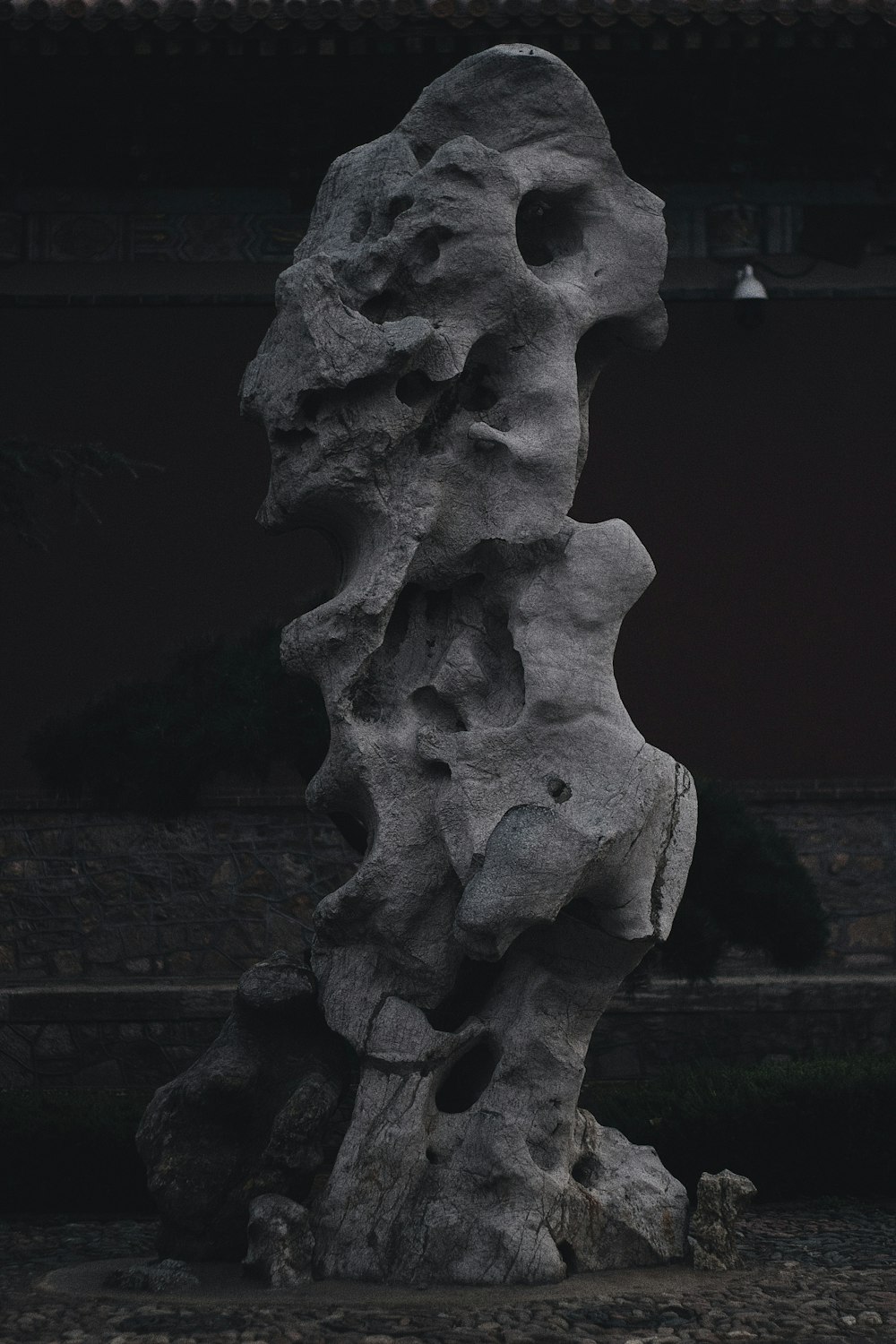 a rock formation in front of a building