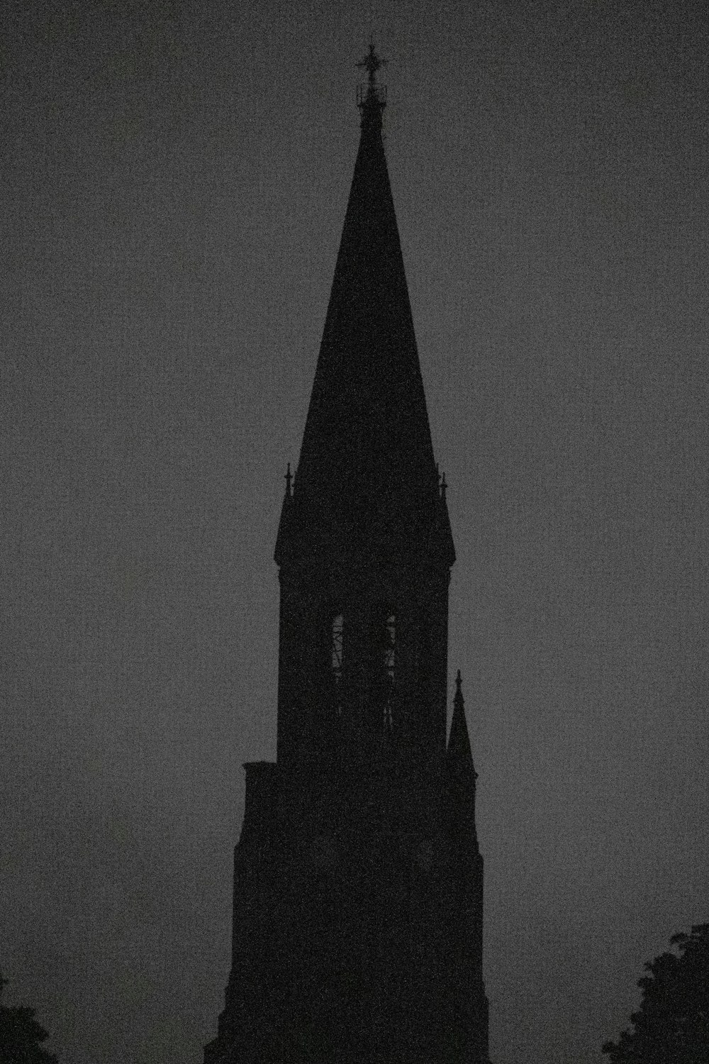 a black and white photo of a church steeple