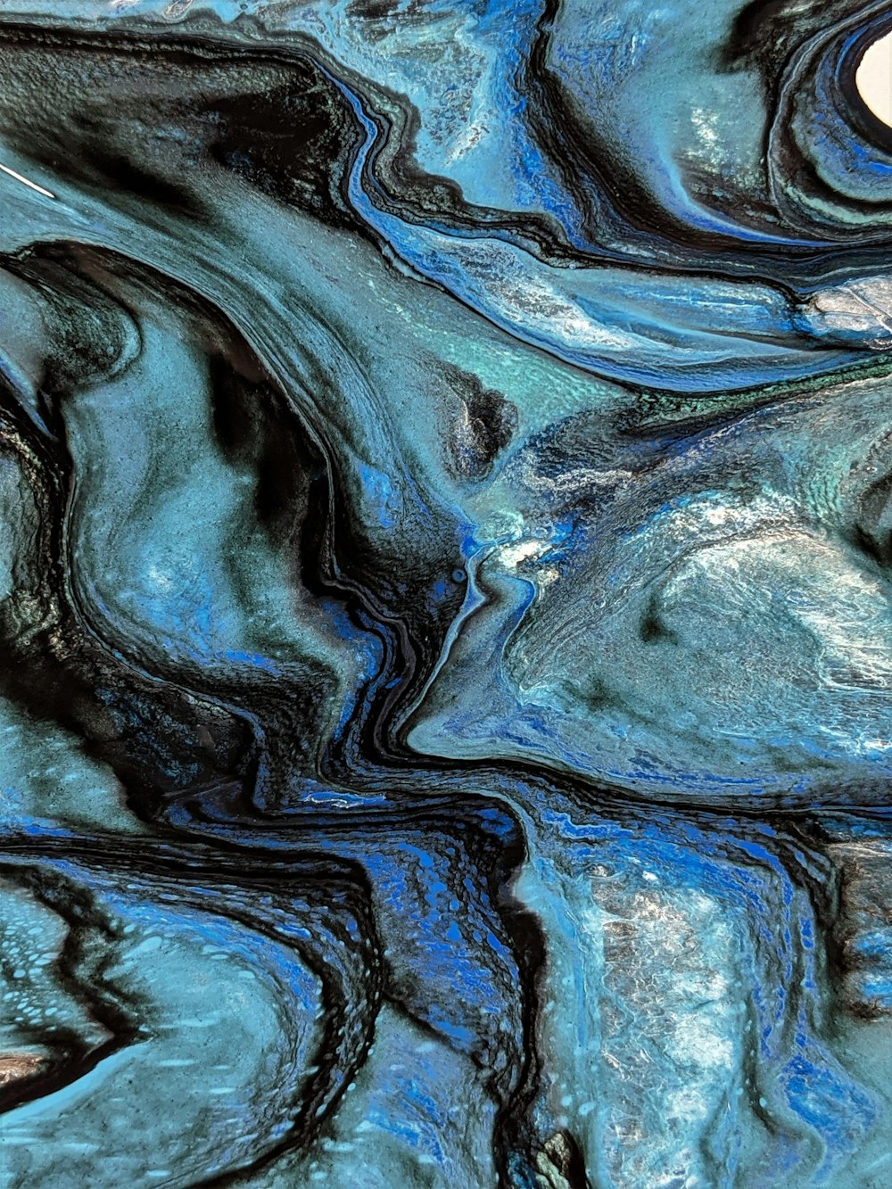 a close up of a blue and black marble