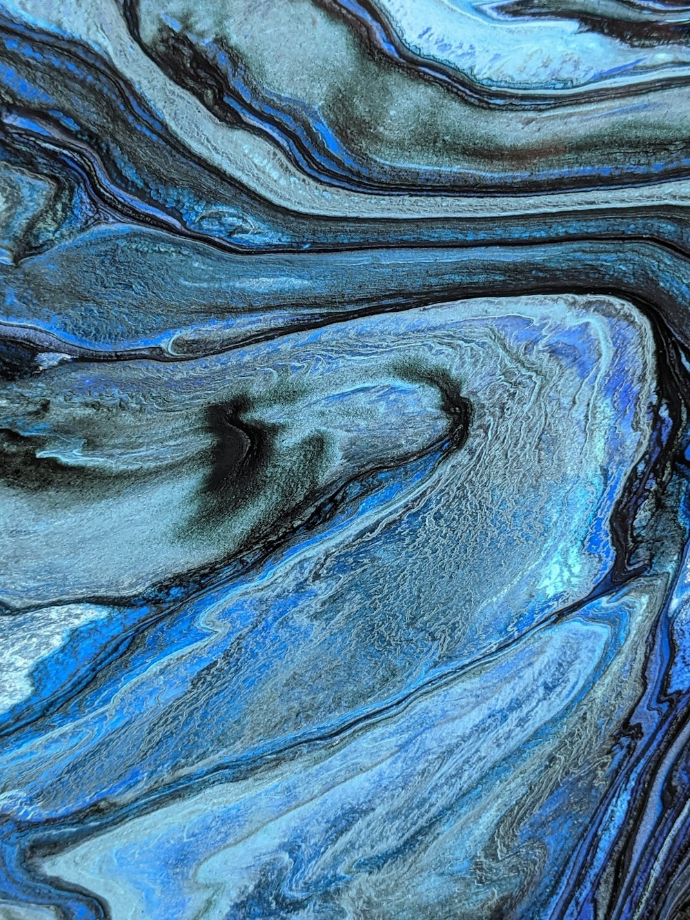 a close up of a blue and black marble