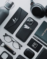 Collection of custom branded merchandise items including caps, pens, and notebooks