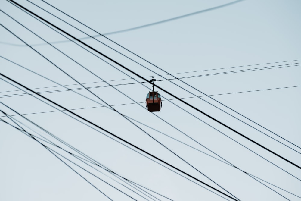 a cable car hanging from the side of a pole