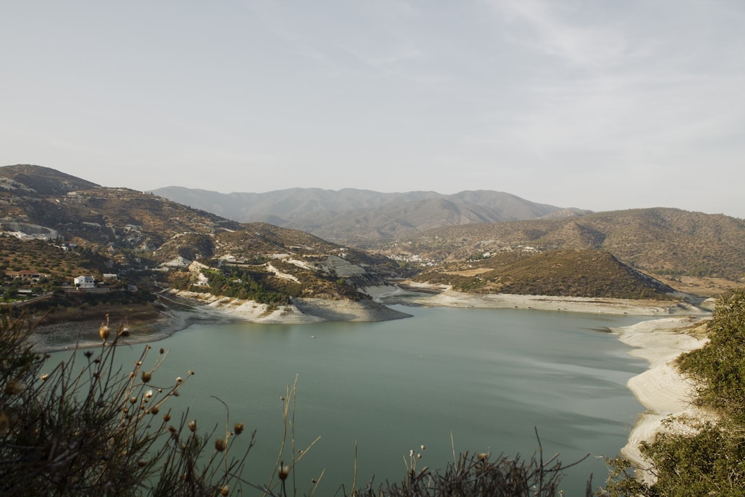 a large body of water surrounded by mountains,