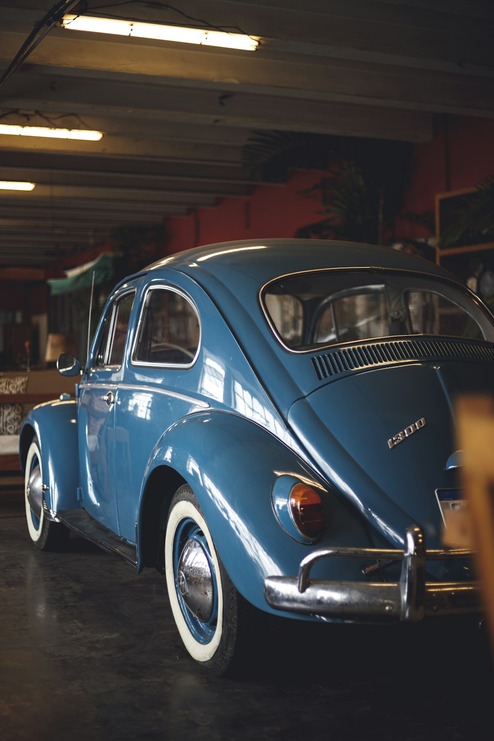 a blue car parked inside of a garage