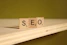 a wooden block that says seo on it