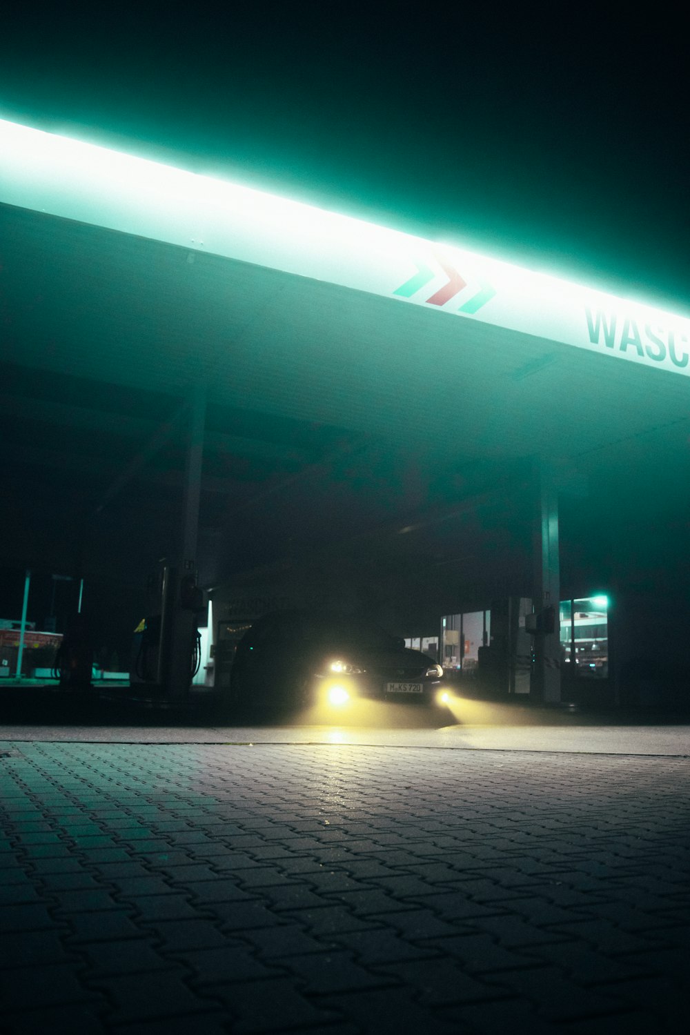 a gas station at night with the lights on