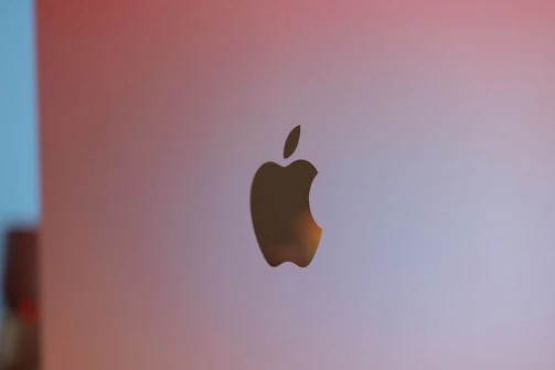 Close-up of the Apple logo in elegant grayscale, clickable and highlighted on hover.