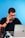 a man sitting at a desk talking on a cell phone