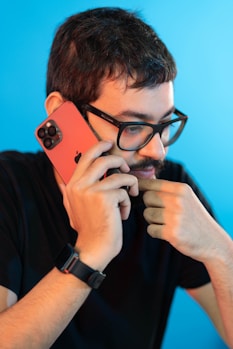 a man holding a cell phone up to his face